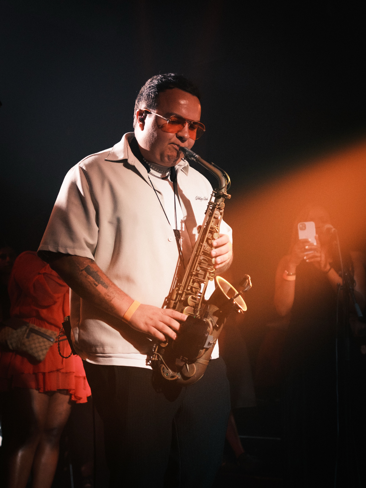 Sax player performing alongside DJ entertainment